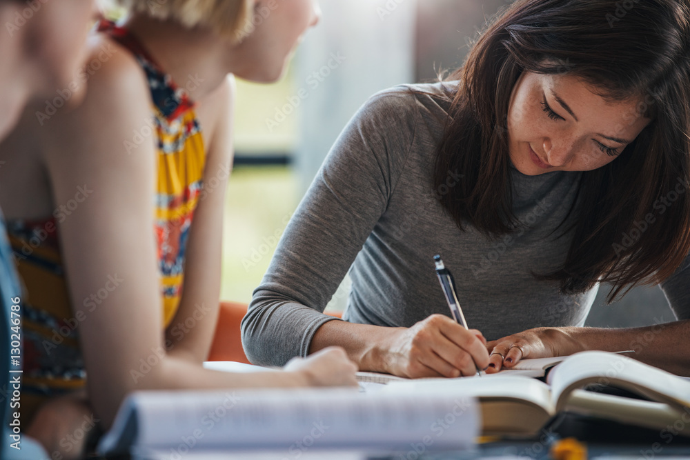 Students at library preparing school assignment