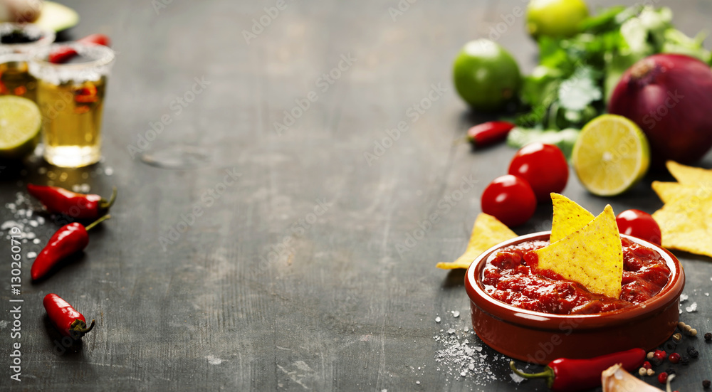 Fresh salsa dips with nachos chips on old background