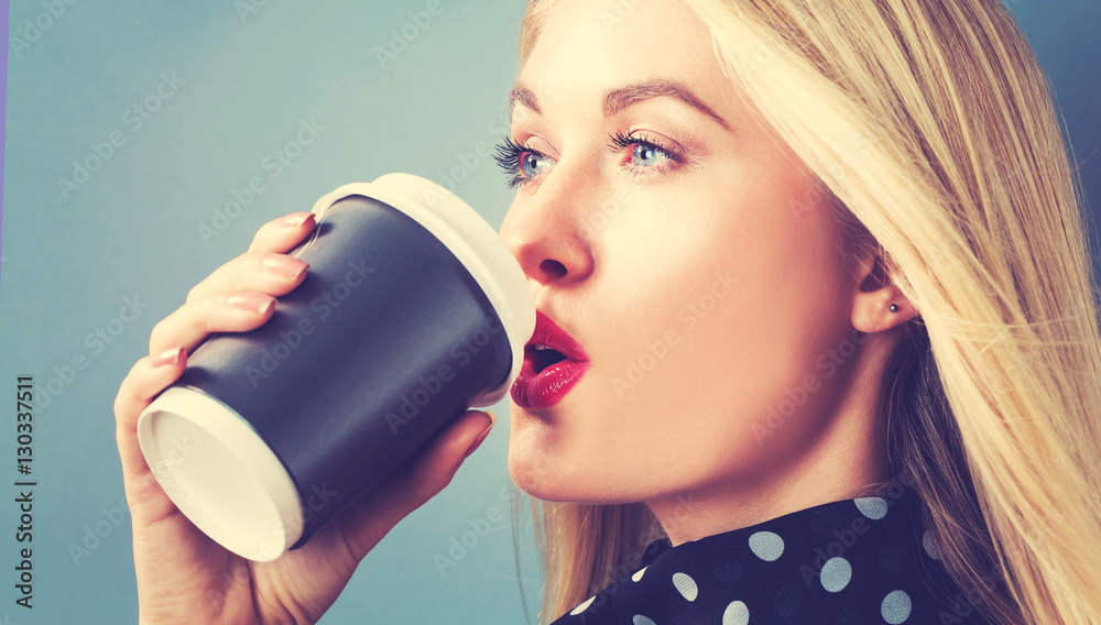 Young blonde woman drinking coffee