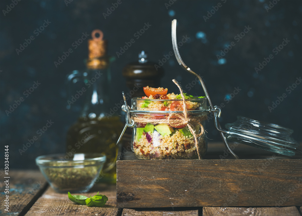 Homemade jar quinoa salad with cherry tomatoes and sun-dried tomatoes, avocado, basil. Detox, dietin