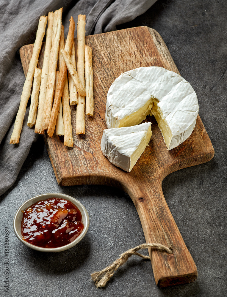 camembert cheese on wooden cutting board