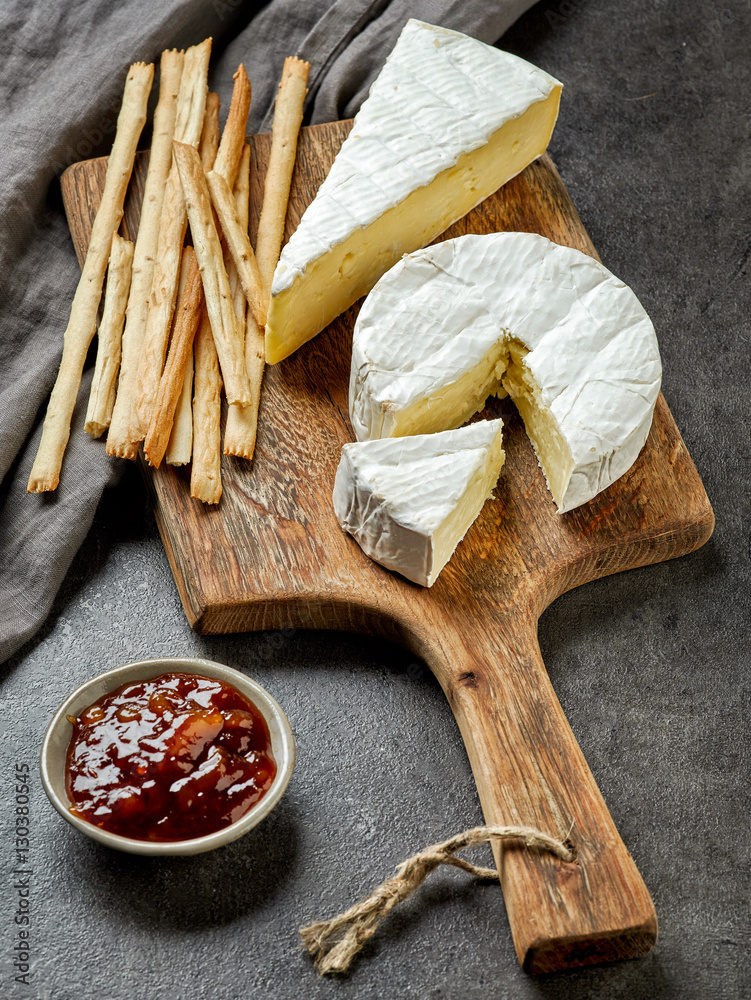 camembert cheese on wooden cutting board