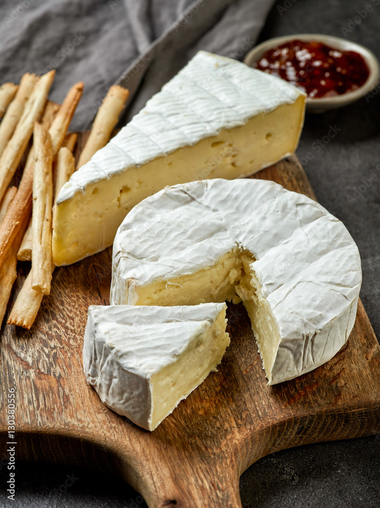 camembert cheese on wooden cutting board