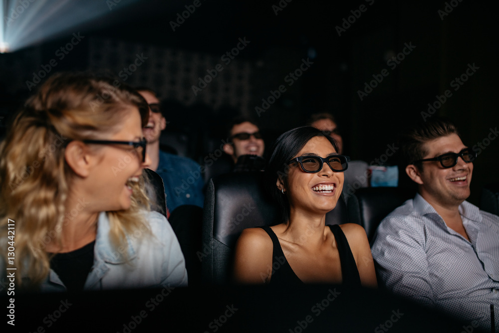 Men and women watching 3d film in theater