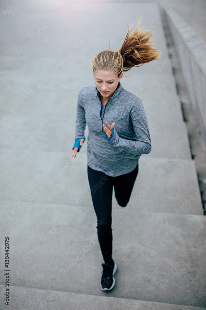 Fitness model doing running workout in morning