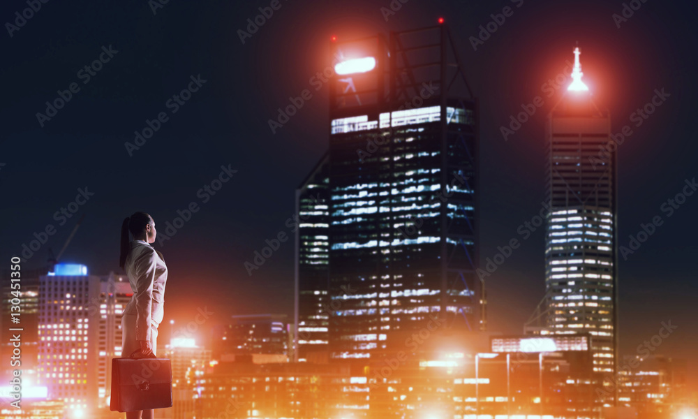 Woman looking at night city