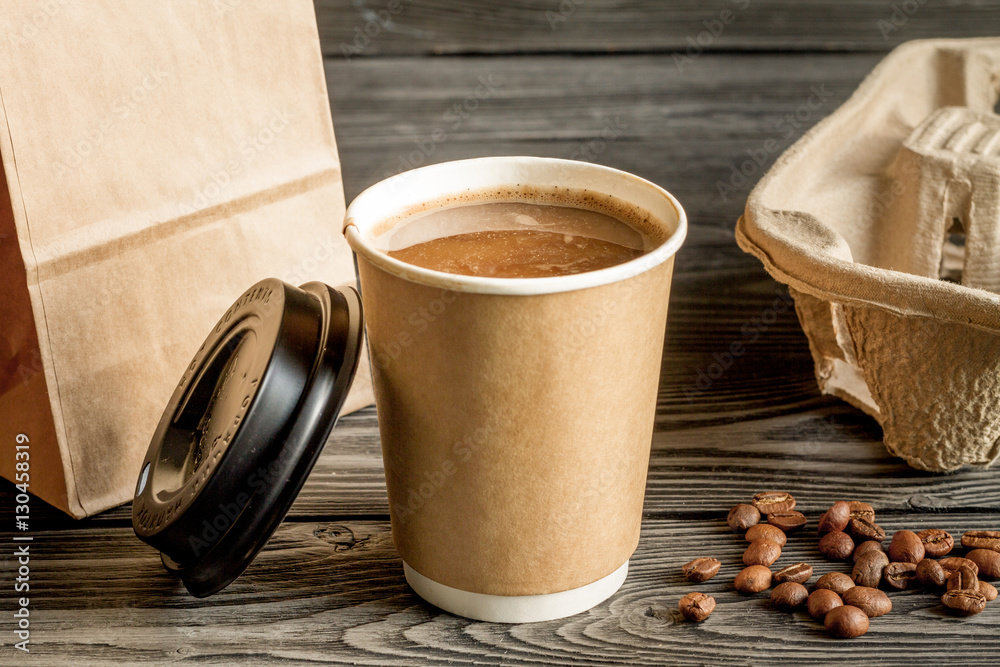 coffee cup to go at wooden background