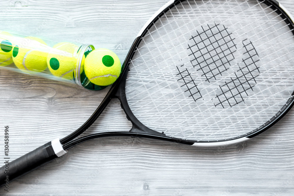 tennis racket on wooden background top view