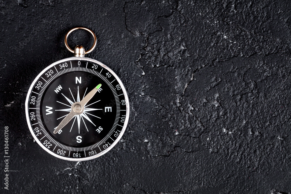 compass on dark background concept - direction motion top view