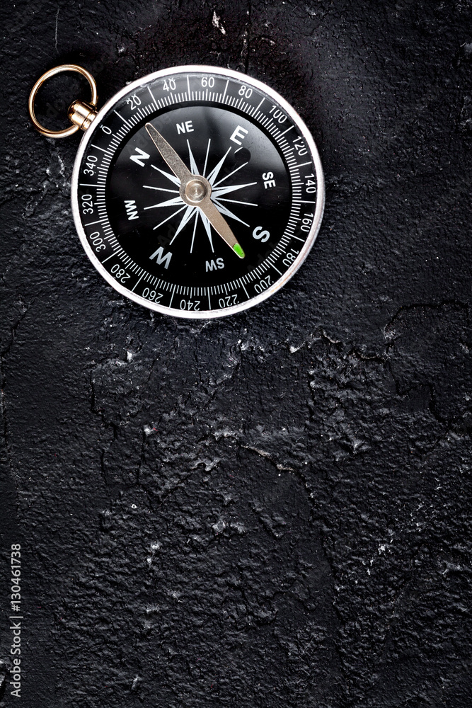 compass on dark background concept - direction motion top view