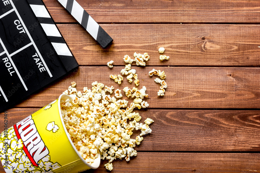 watching movie with popcorn on wooden background top view