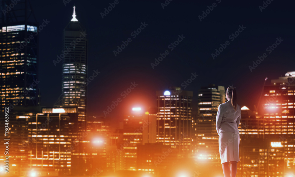 Woman looking at night city