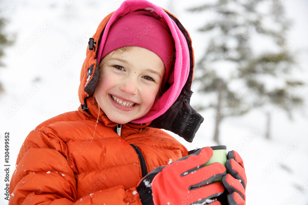 Beautiful girl, enjoying winter, drinking warm thermos tea