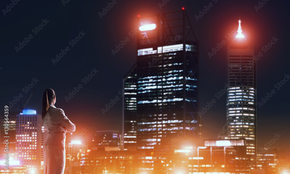 Woman looking at night city