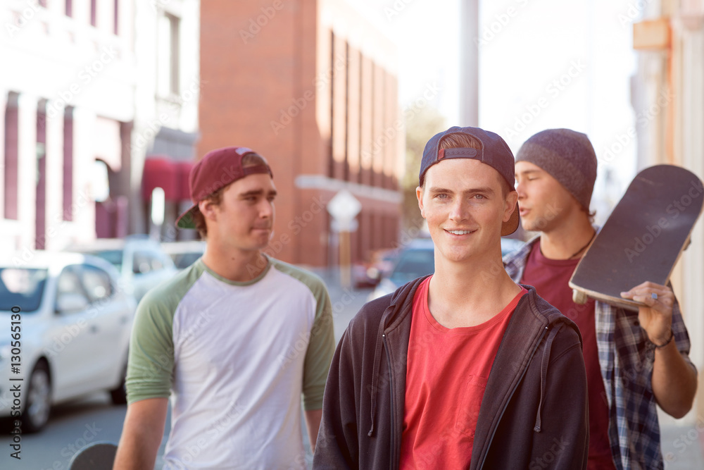 Guys skateboarders in street