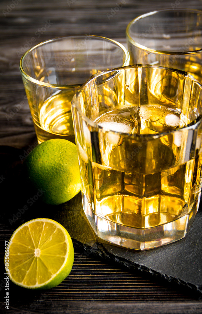 glass of whiskey on dark wooden background