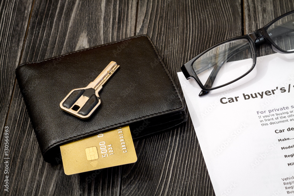 concept of buying car on dark wooden background