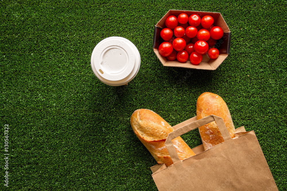 take out in paper bag on green background top view