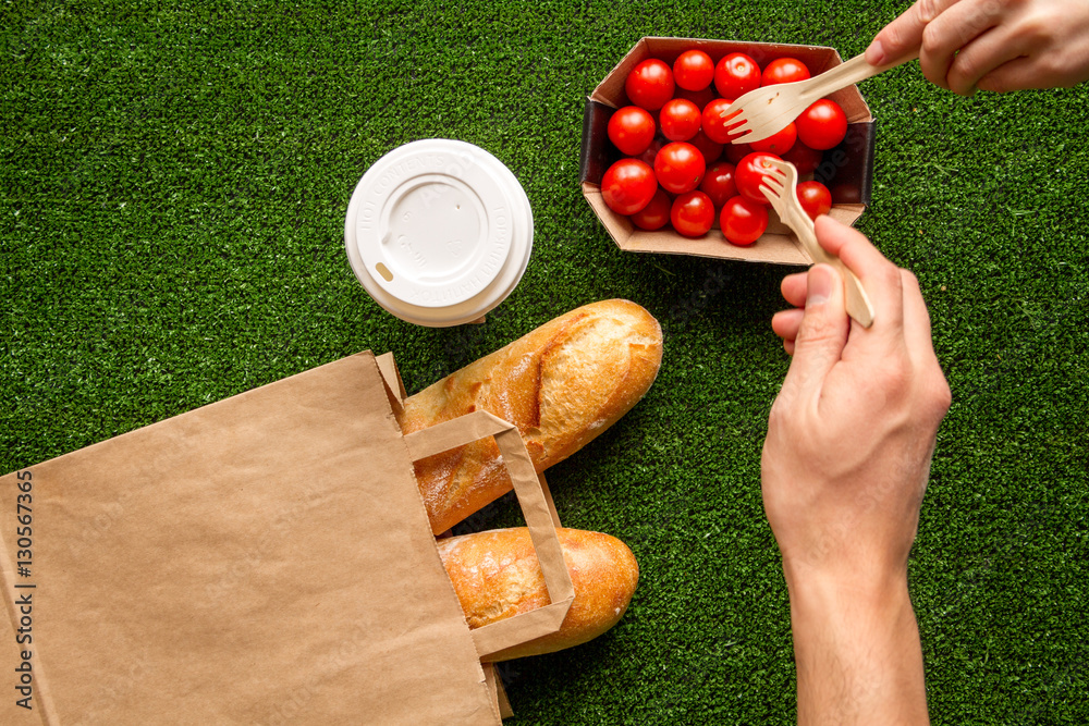 take out in paper bag on green background top view