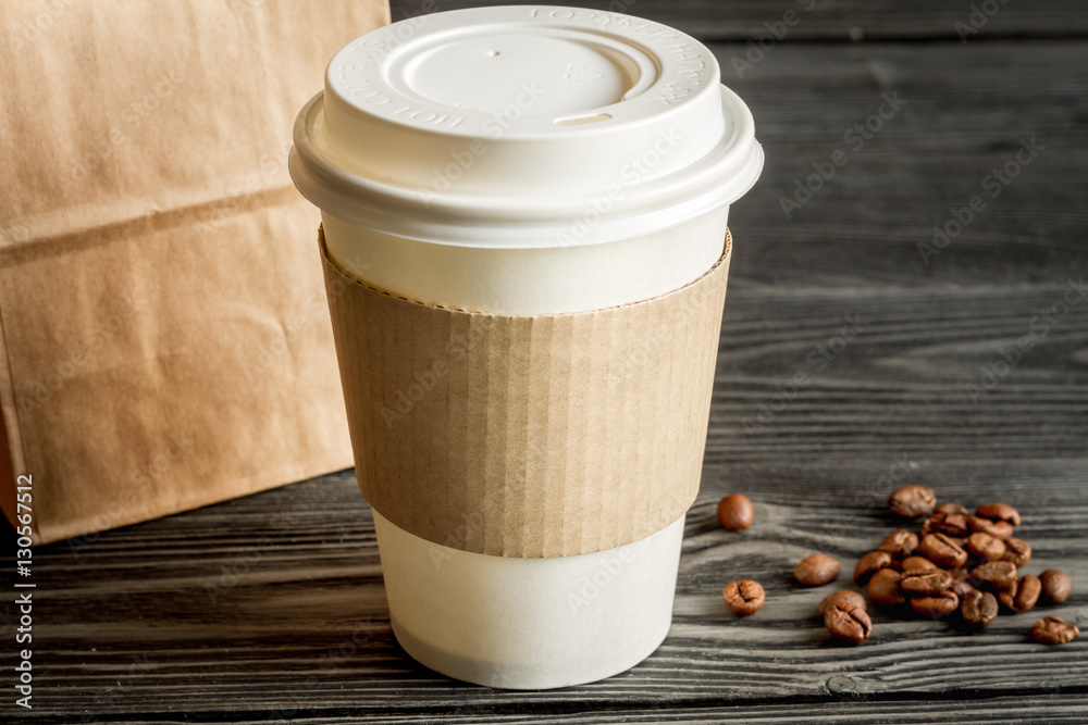 coffee cup to go at wooden background