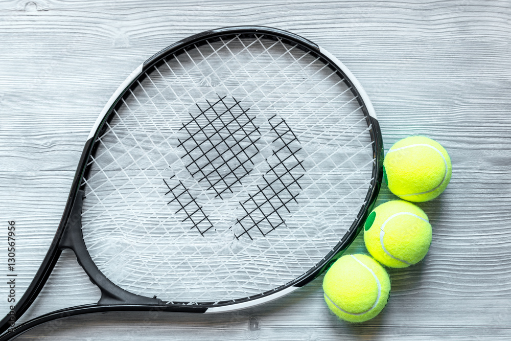 tennis racket on wooden background top view