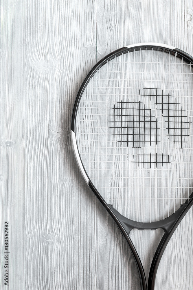 tennis racket on wooden background top view