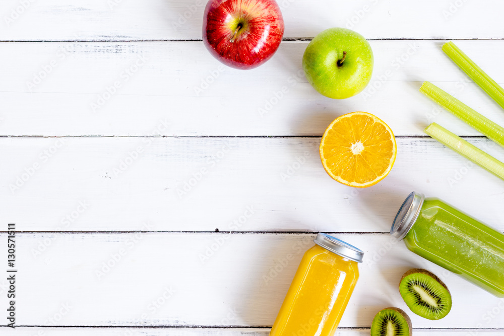 freshly squeezed juices for detox on wooden background top view