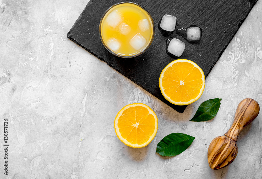 freshly squeezed orange juice on concrete background top view