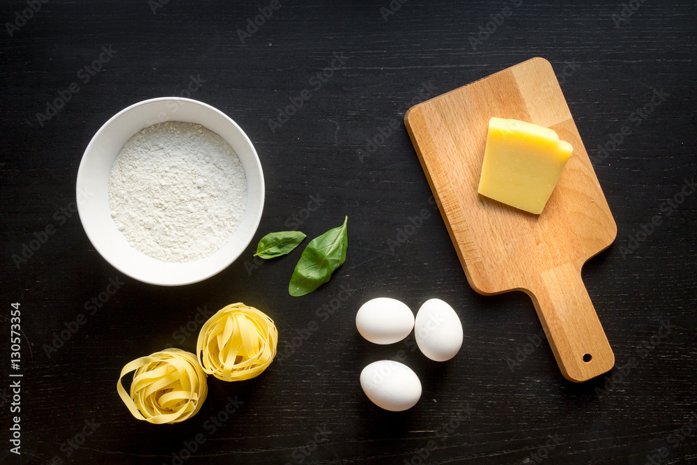 cooking process of pasta on dark background top view