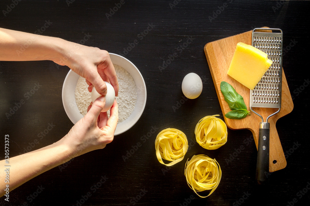 chef cooking pasta top view on dark background