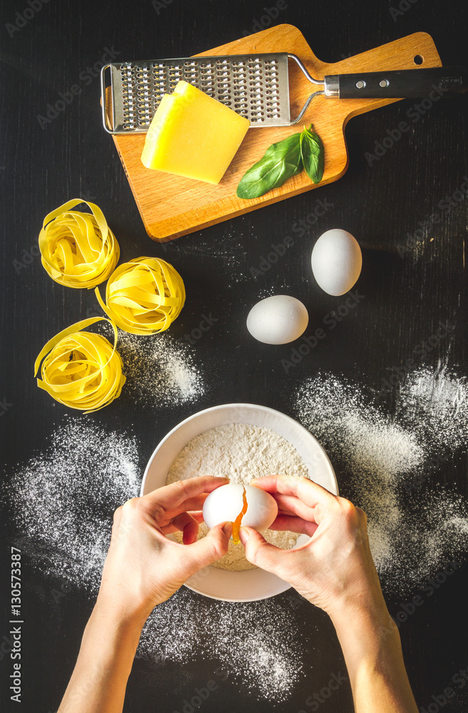 chef cooking pasta top view on dark background