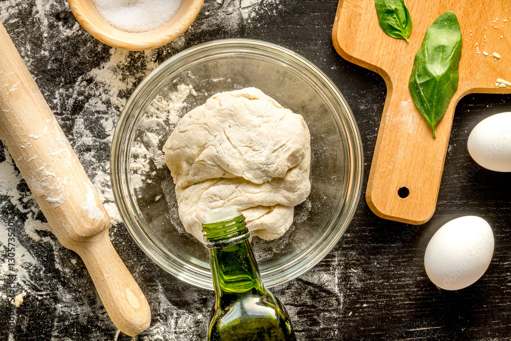 cooking process of pasta on dark background top view