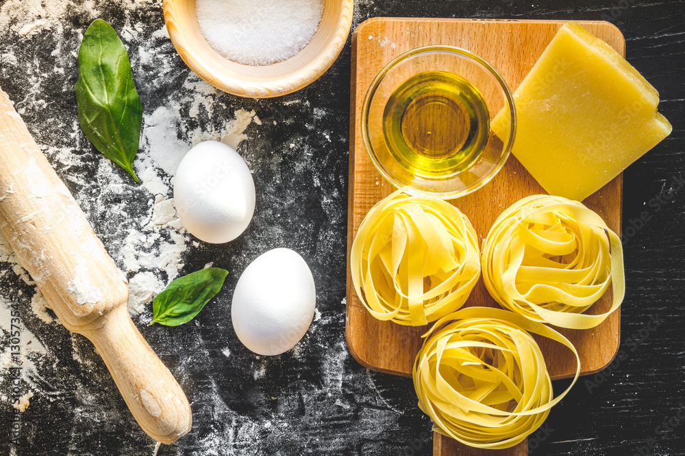 cooking process of pasta on dark background top view