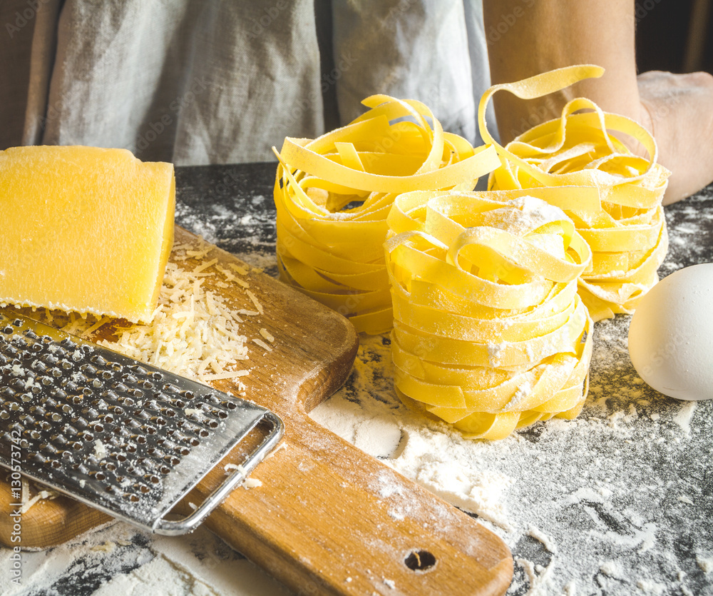 cooking pasta by chef in kitchen on dark background