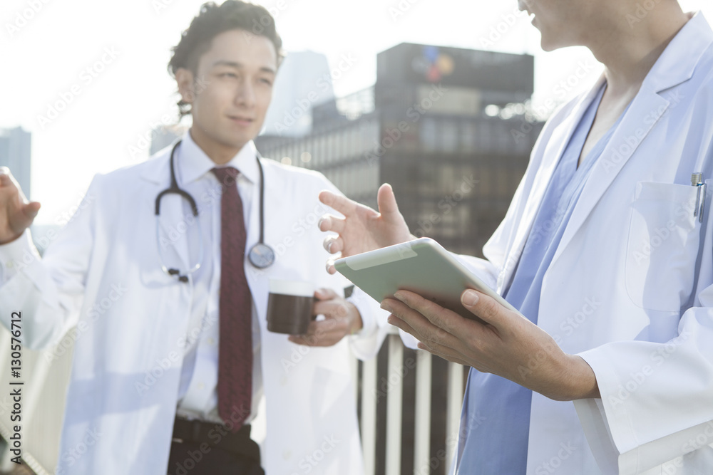 Two doctors are talking on the rooftop