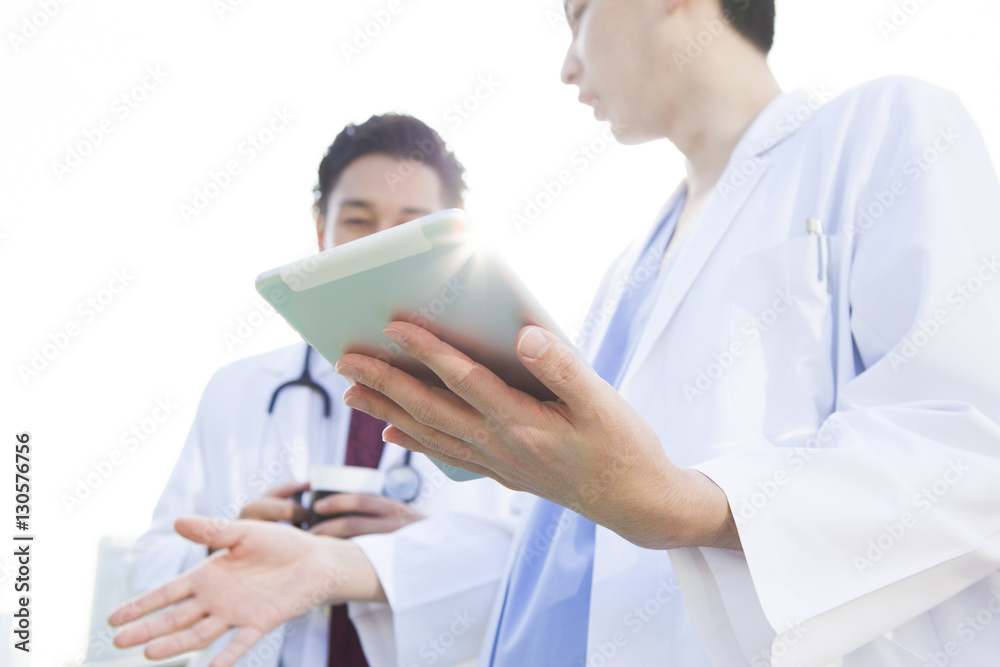 Two doctors are talking on the rooftop