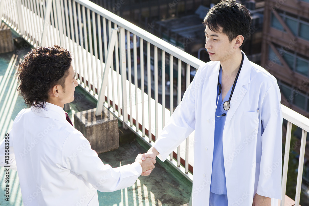 Doctors are shaking hands at the hospitals rooftop