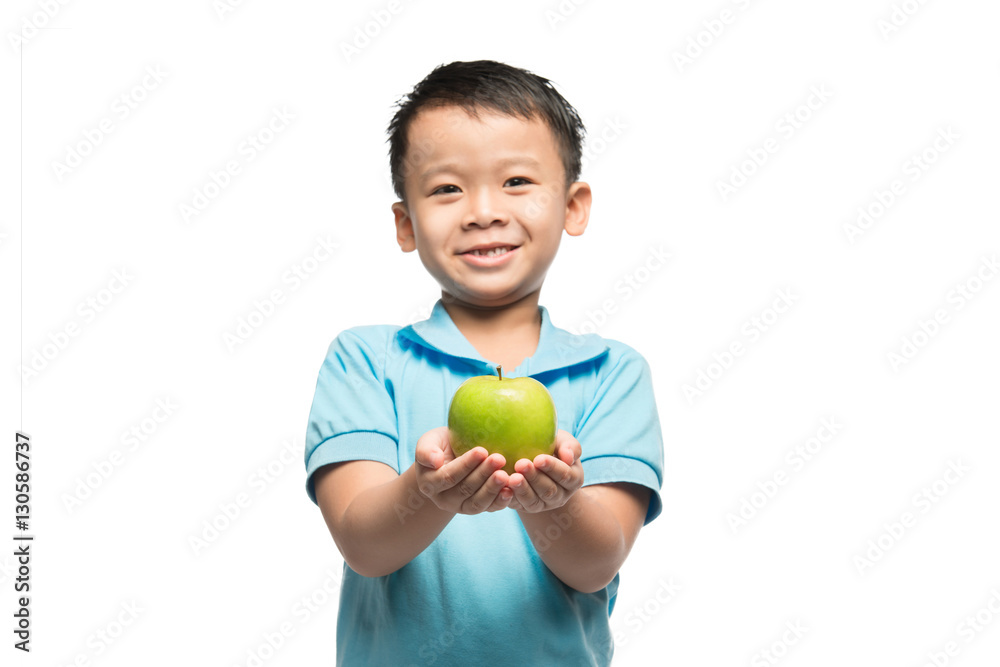 Asian baby boy holding and eating red apple, isolated on white