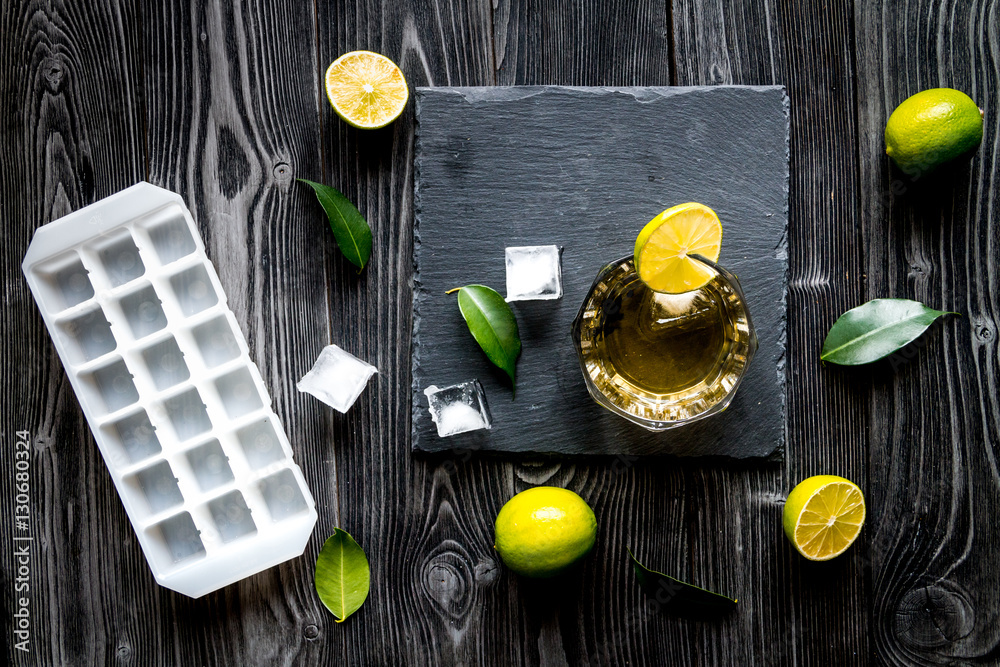 glass of whiskey on dark wooden background top view