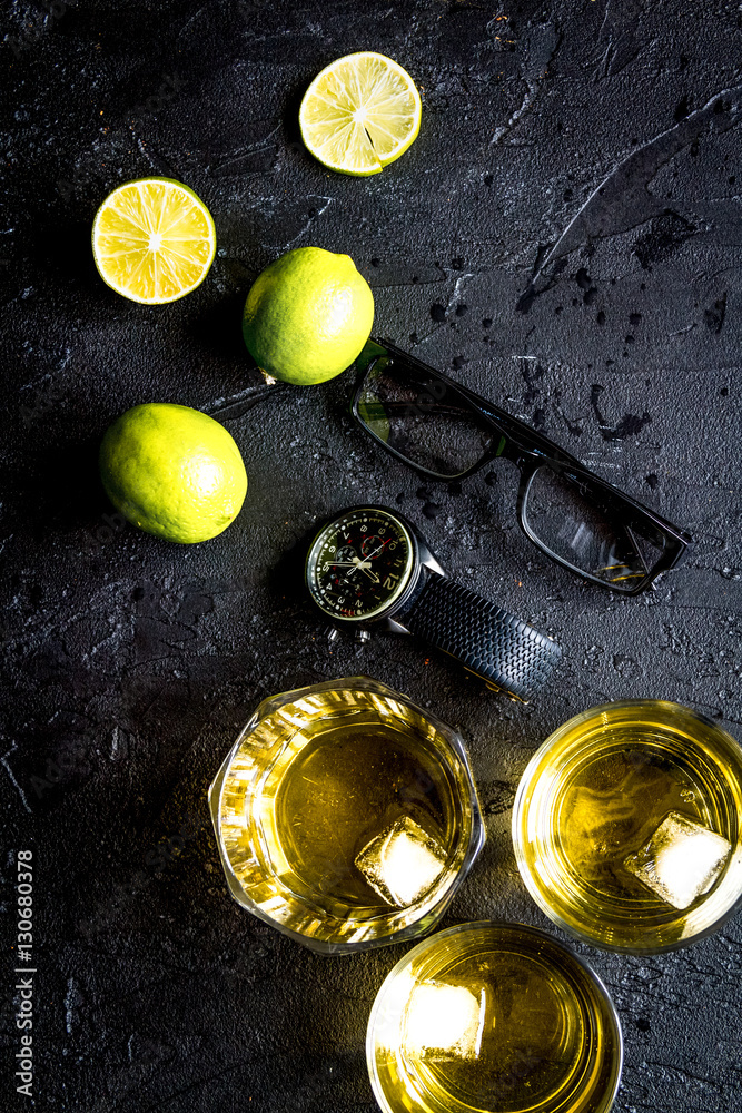 glass of scotch on dark background top view