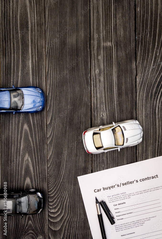 concept of buying car on dark wooden background top view