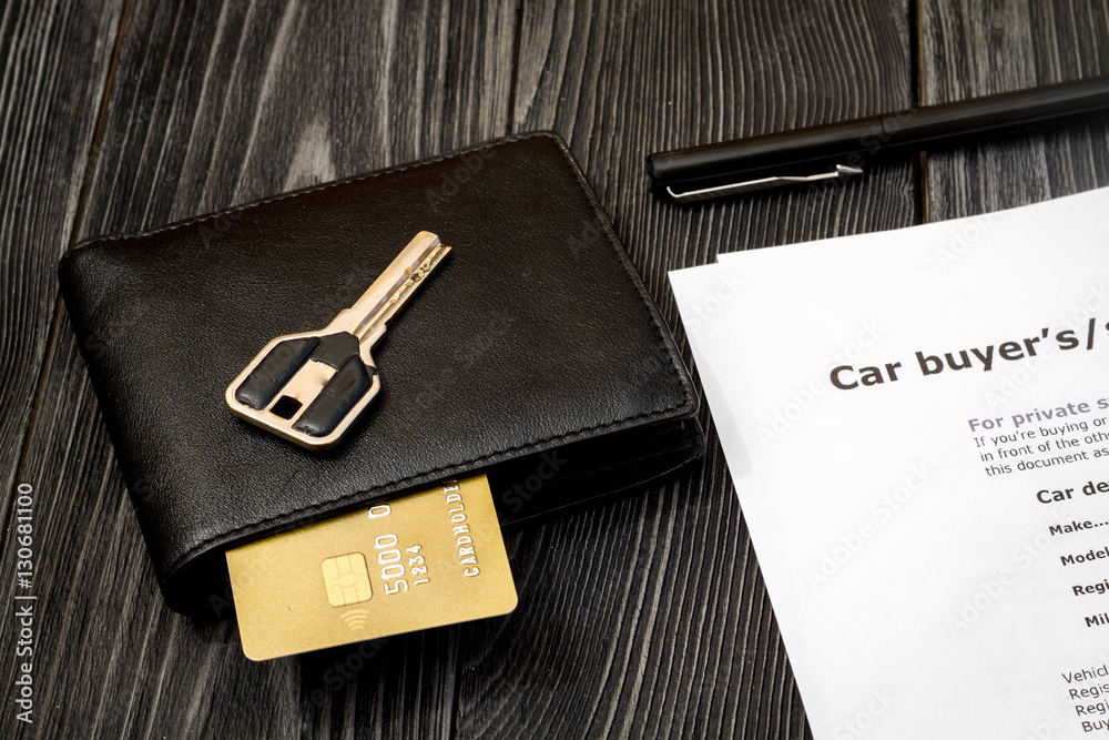 concept of buying car on dark wooden background