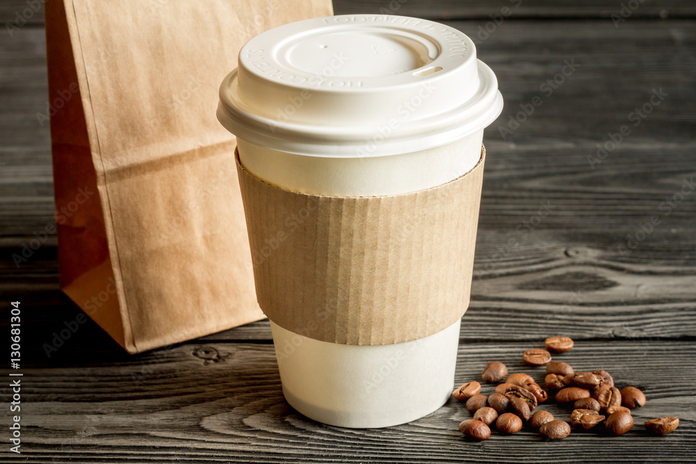 coffee cup to go at wooden background