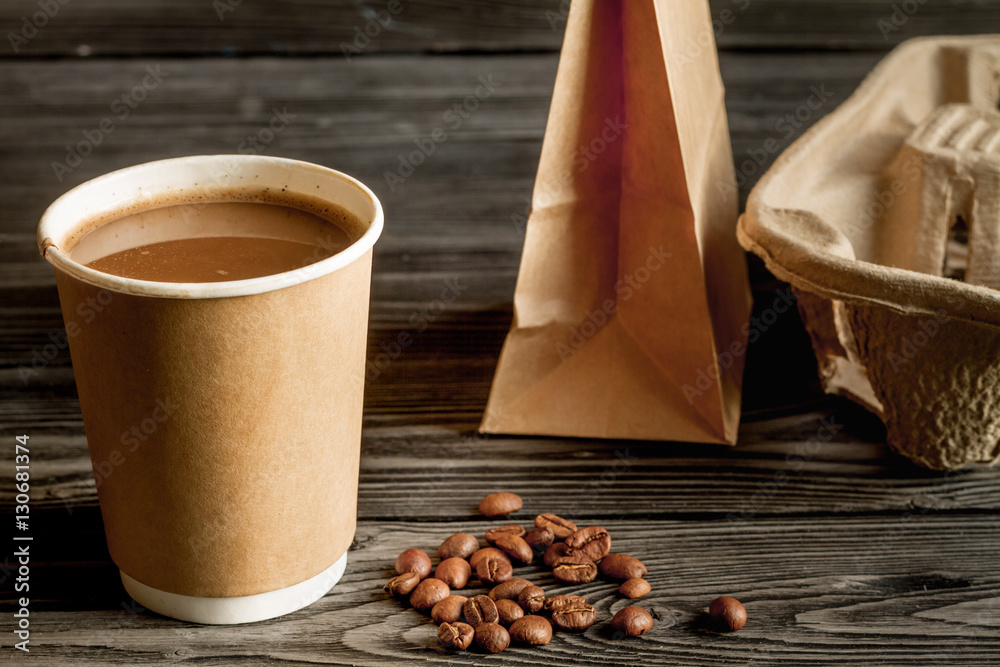 coffee cup to go at wooden background