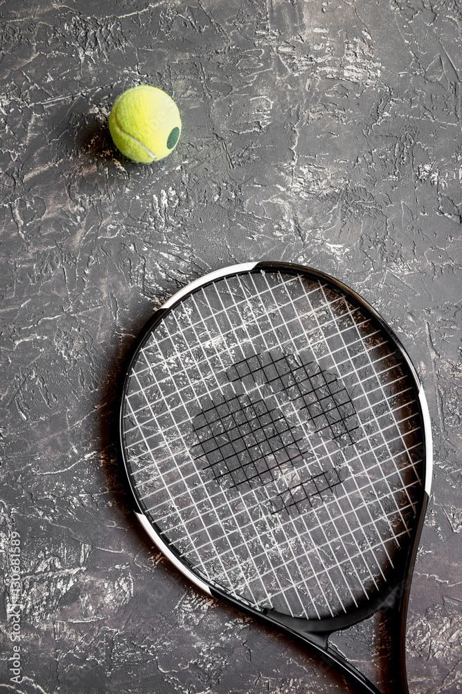 tennis racket on gray background top view