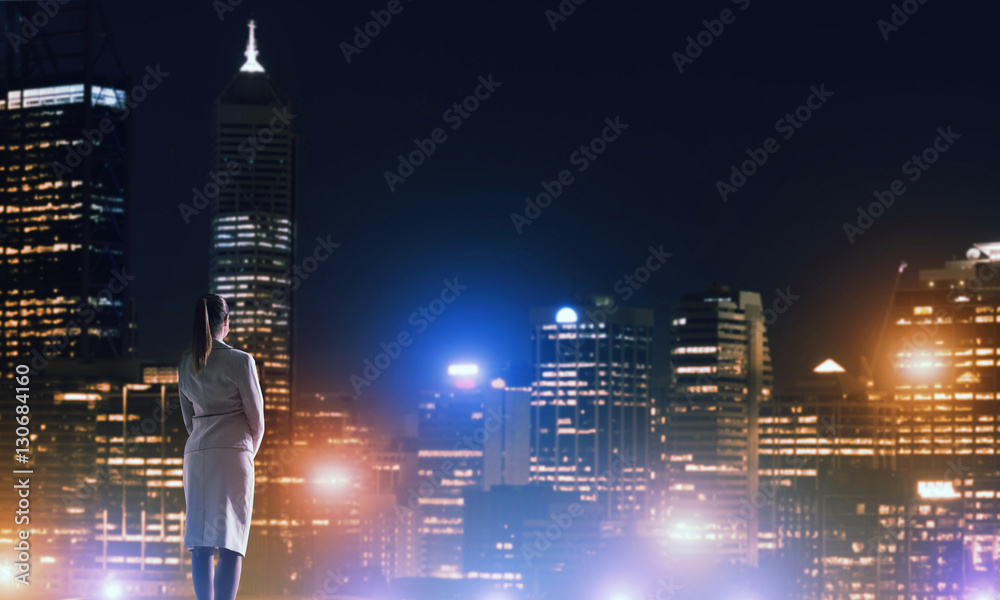 Woman looking at night city