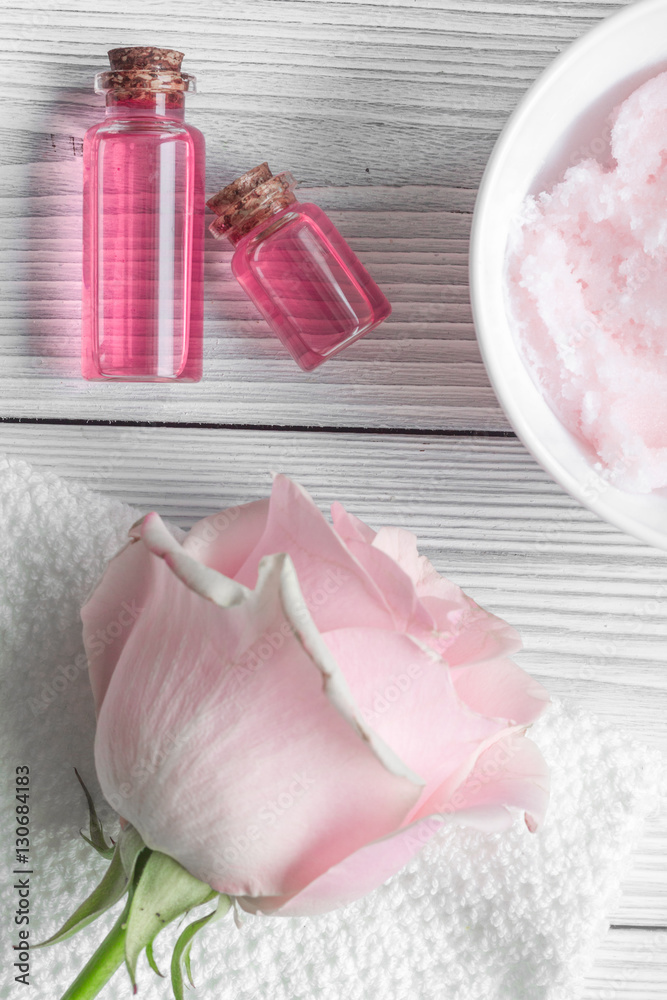 organic cosmetic with rose oil on wooden background top view