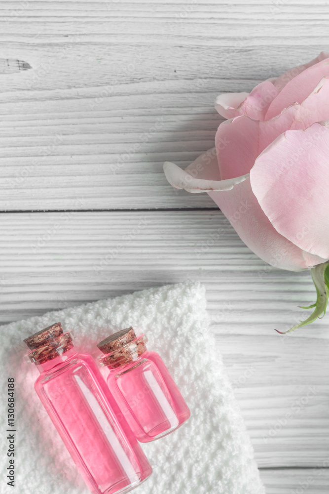 organic cosmetic with rose oil on wooden background top view