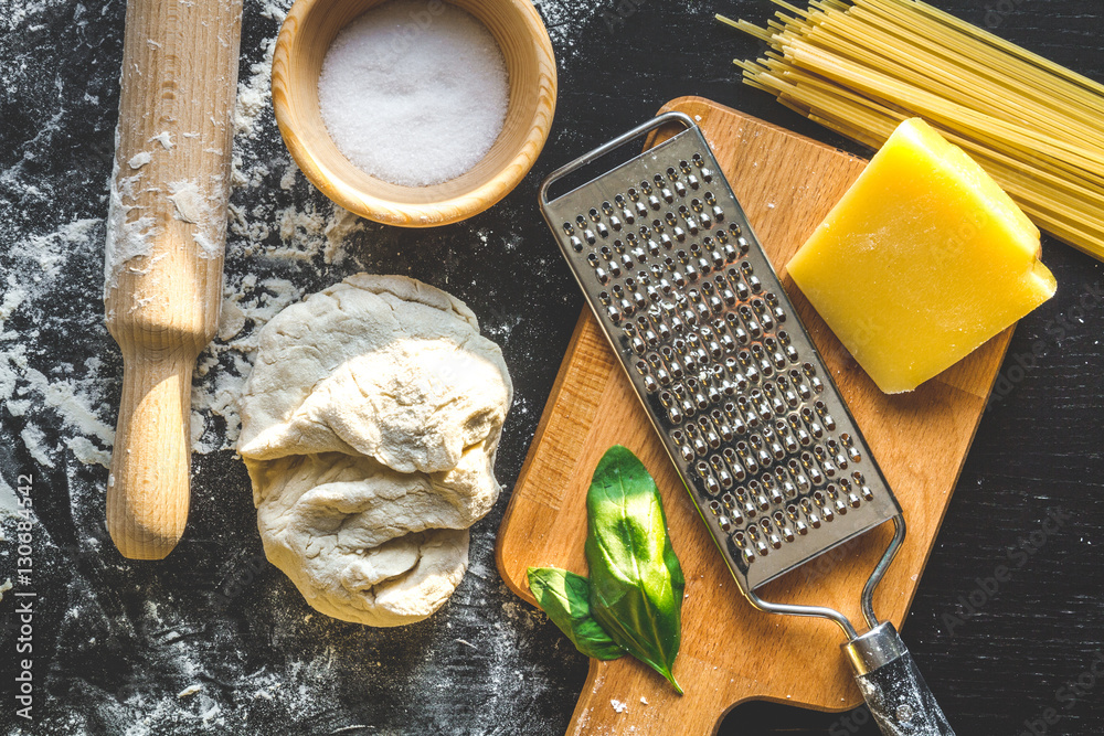 cooking process of pasta on dark background top view