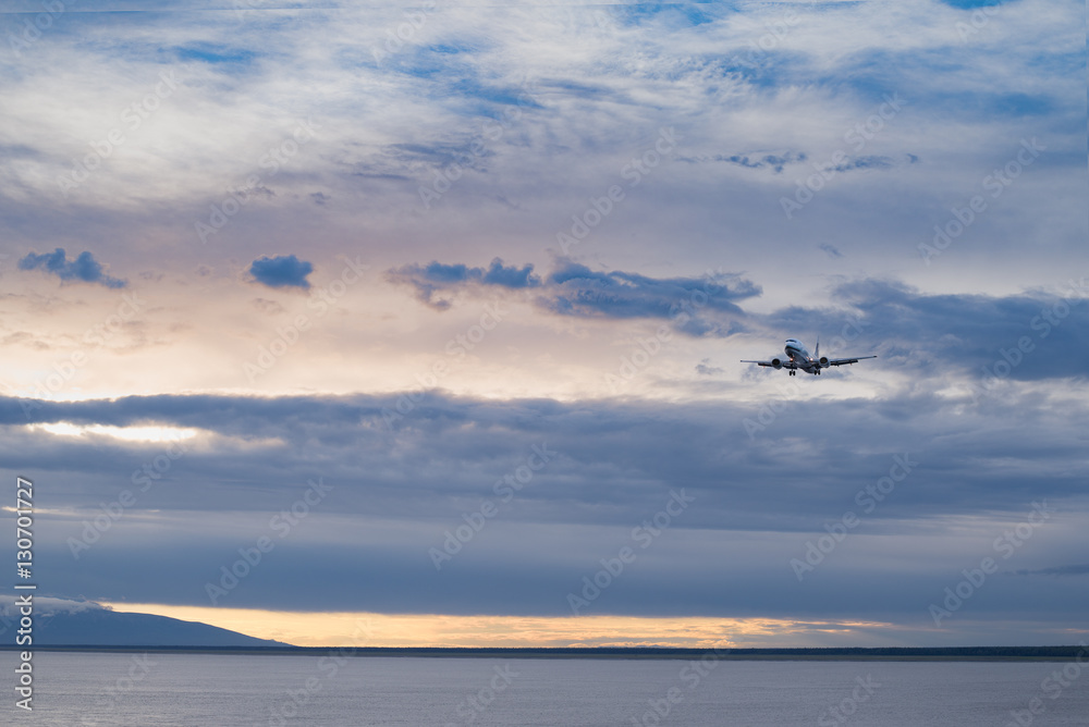 Sunset in Alaska with Plane is landing